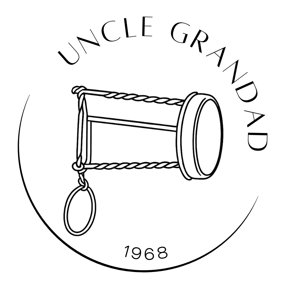 Circular Uncle Grandad logo. The text “Uncle Grandad” curves across the top. In the centre is a line art illustration of a handcrafted wire duck caller. The year “1968” appears at the bottom of the circle.